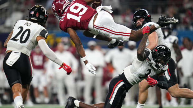 Cincinnati Bearcats safety Ja'von Hicks (3) upends Alabama Crimson Tide tight end Jahleel Billingsley in the second quarter during the College Football Playoff semifinal game at the 86th Cotton Bowl Classic, Friday, Dec. 31, 2021, at AT&T Stadium in Arlington, Texas.